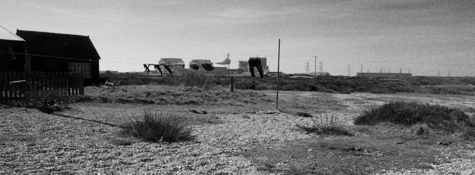 Washing line with clothes drying in front of Dungeness nuclear power station, shingle beach fisherman's hut, Kent, documentary photography