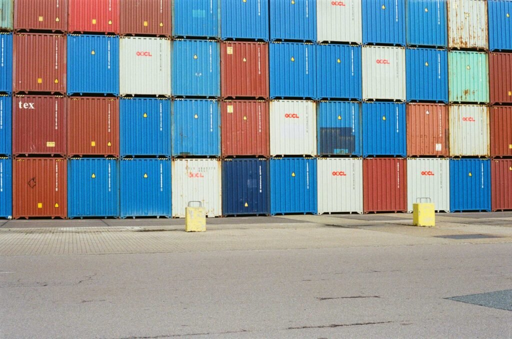 A grid of blue, red and white OOCL shipping containers stacked at the Port of Felixstowe, Suffolk