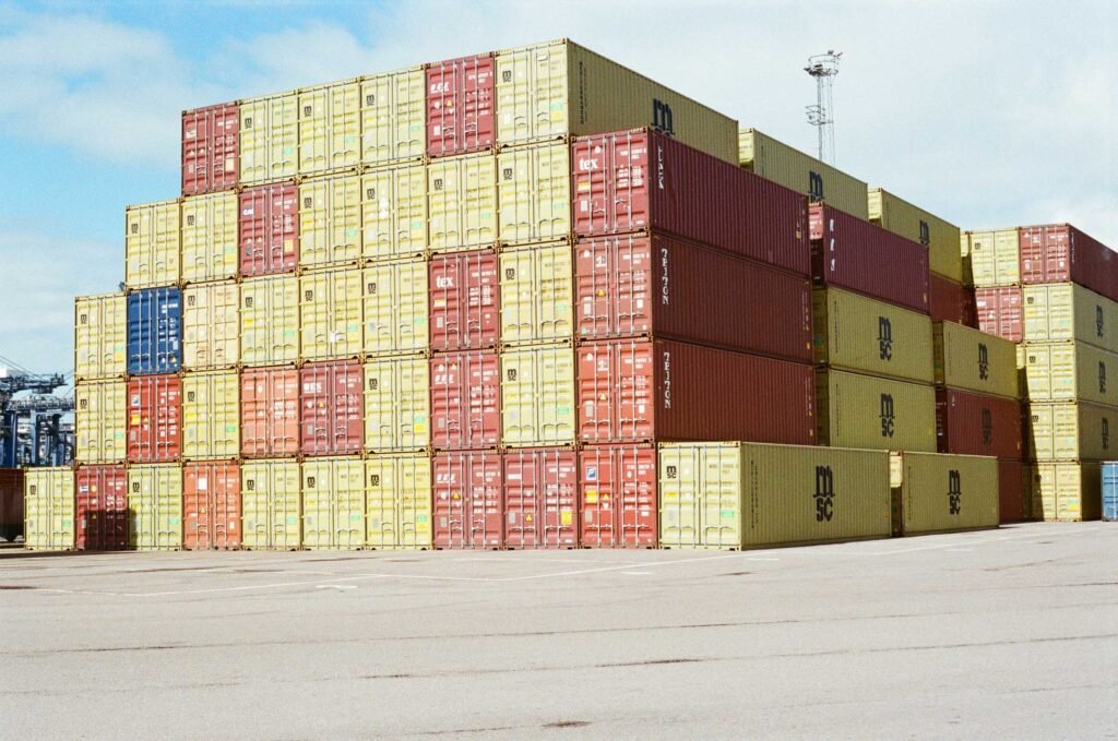 Stacks of red and yellow shipping containers at the Port of Felixstowe, photographed on colour film