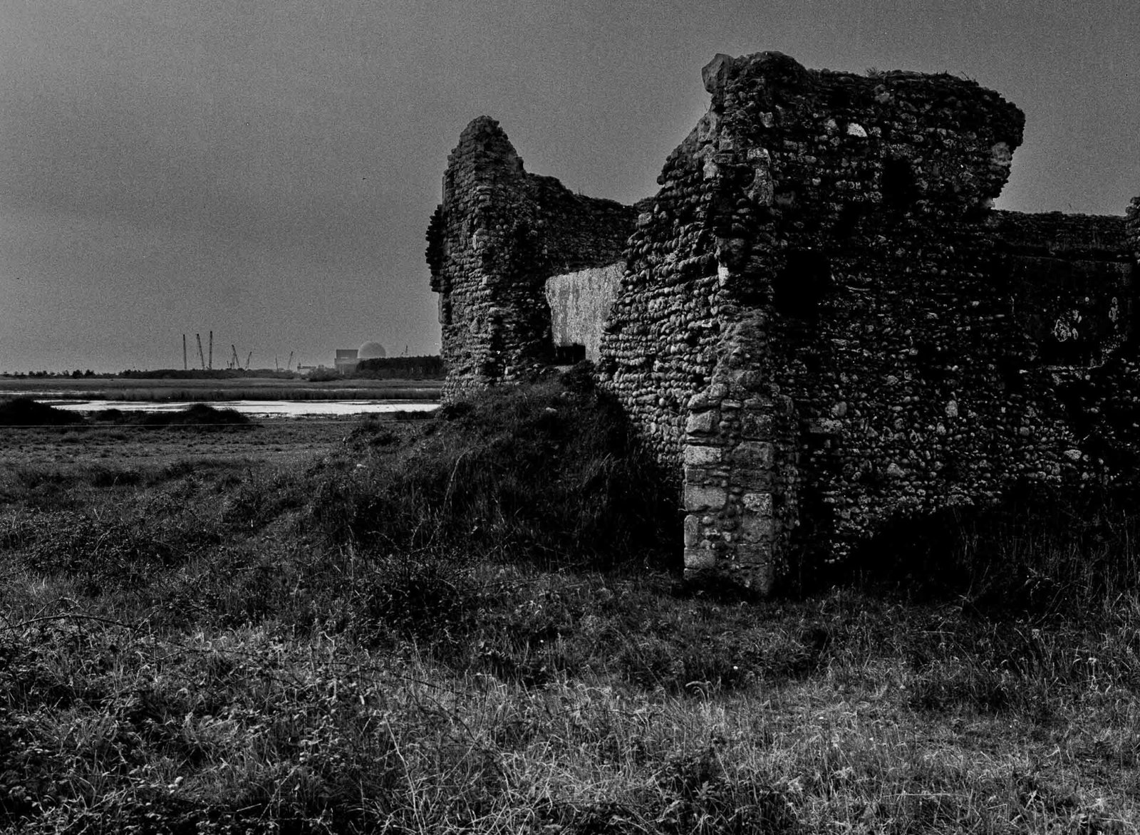 The ruins of Leiston Abbey in Suffolk, with the dome of Sizewell B nuclear power station visible across Minsmere Marsh in the distance