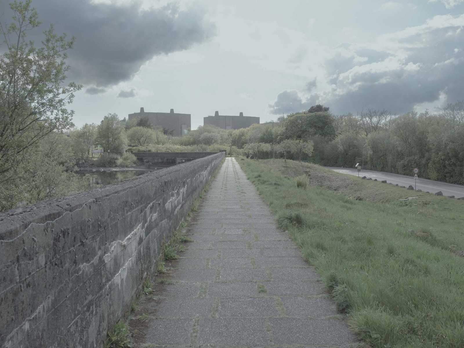 Stone causeway leading toward the decommissioned Trawsfynydd nuclear reactors, Eryri National Park, Wales